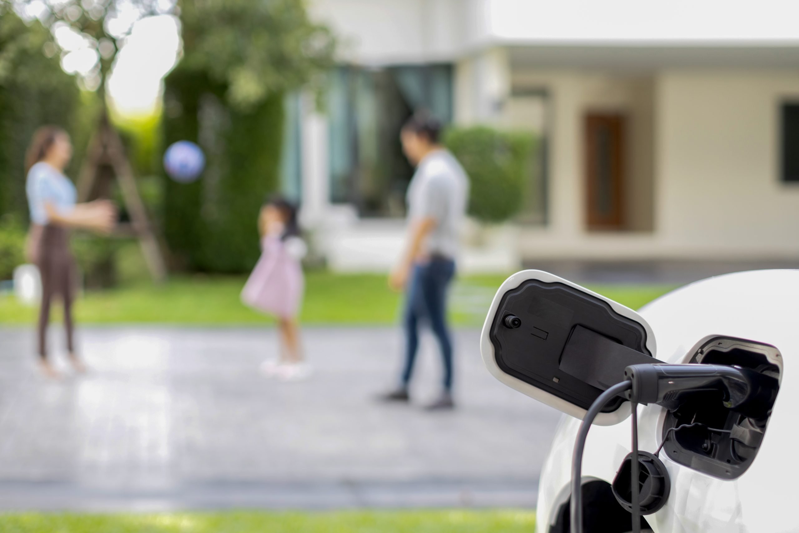 50326630 focus ev charger recharge ev car at home with progressive family in background scaled